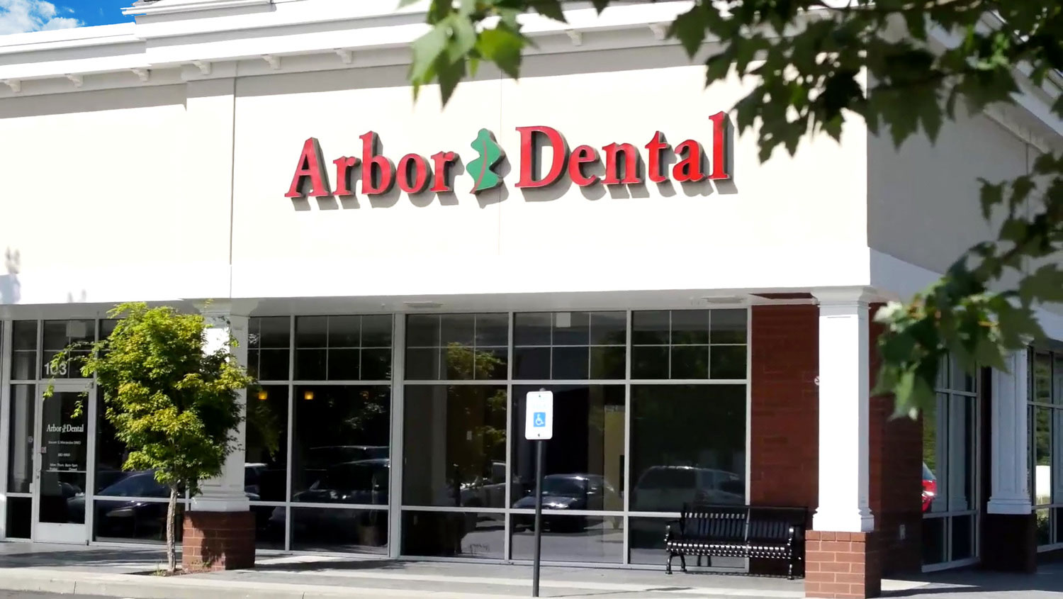 The image features a storefront with a sign that reads Arbor Dental prominently displayed above the entrance, indicating the name of the business located within the building.