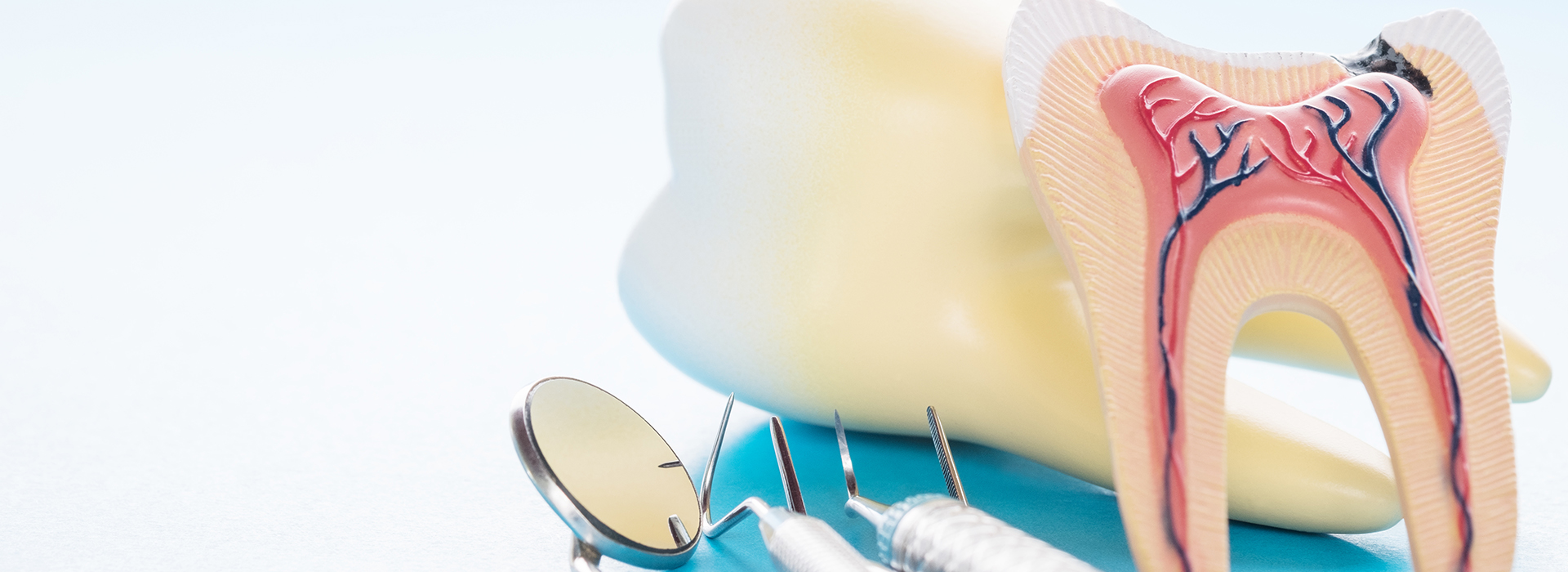 The image shows a close-up view of dental tools, including a toothbrush, toothpaste, and dental floss, with a focus on oral hygiene items commonly used for cleaning teeth.